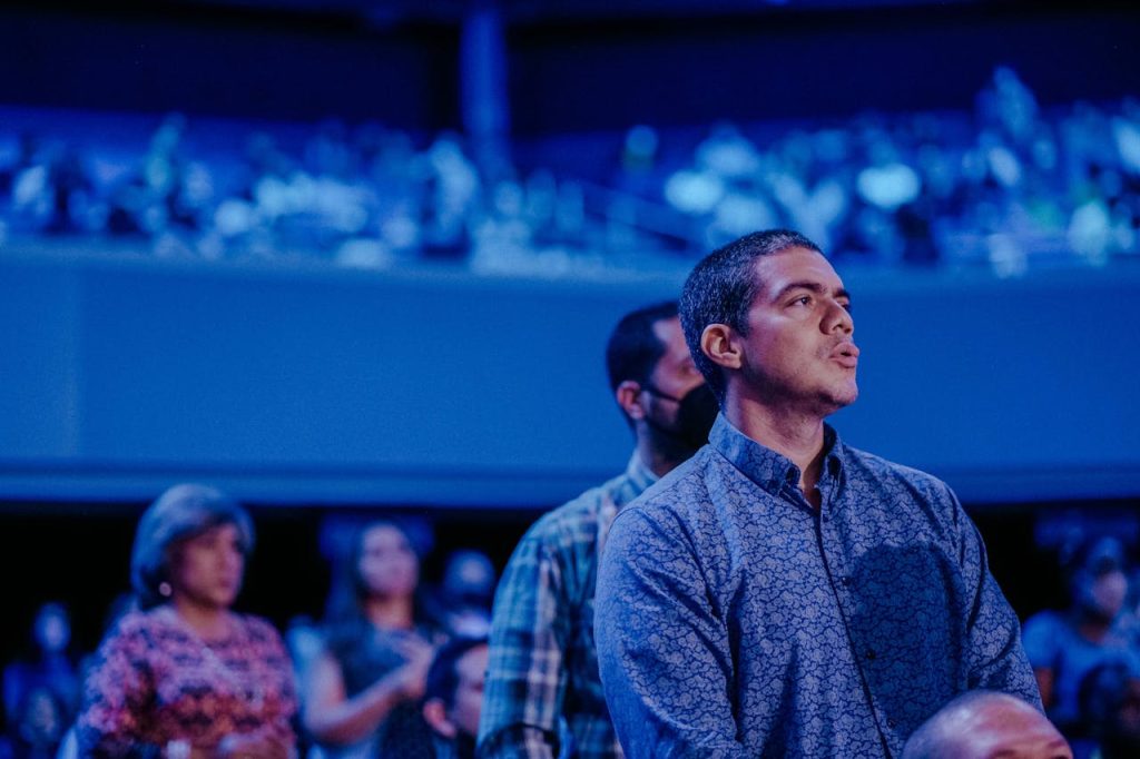 A diverse audience attentively engaging during a significant indoor event.